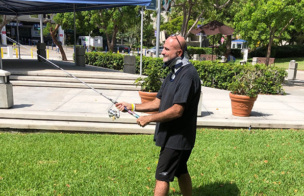 Ed Navarro outdoors with a fishing rod