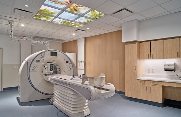 hospital room with body scanning machine in the middle of it