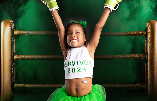 girl in boxing gear raising her arms