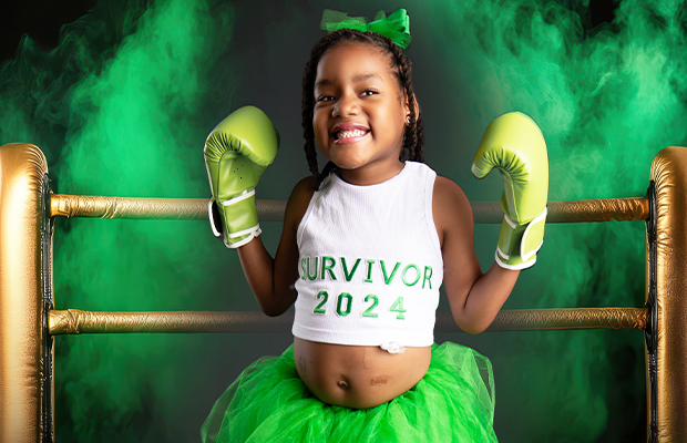 girl with boxing gloves wearing blouse that says survivor