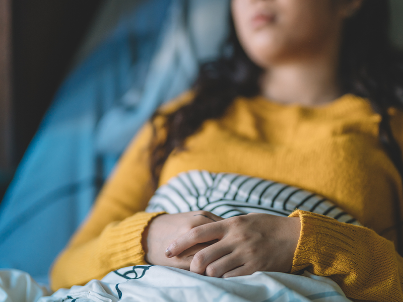 sick woman lying in her bed