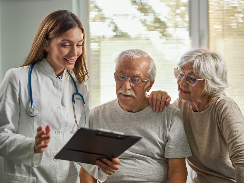 doctor attending consultation of elderly couple