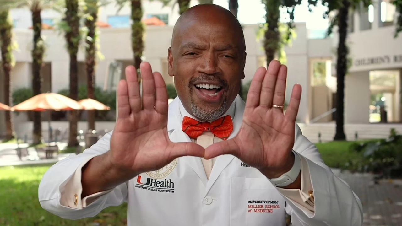doctor smiling and making a sign with his hands
