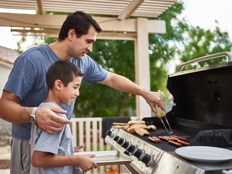 Father and son having a barbecue