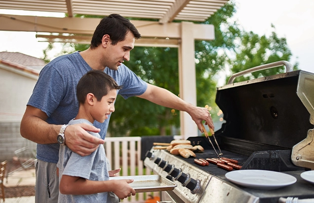 Father and son having a barbecue