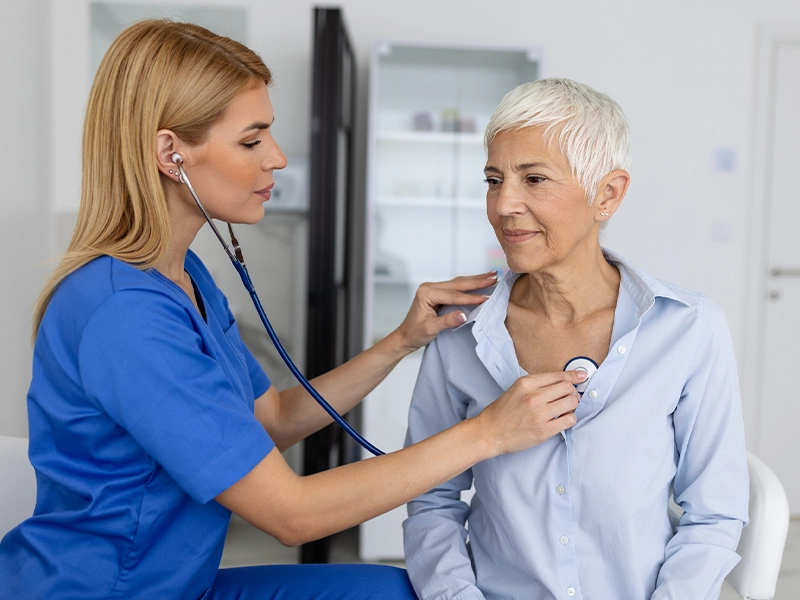 female doctor examining an adult woman
