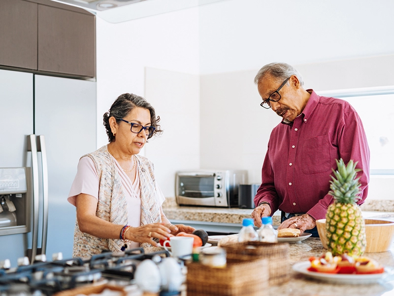 elderly couple cooking