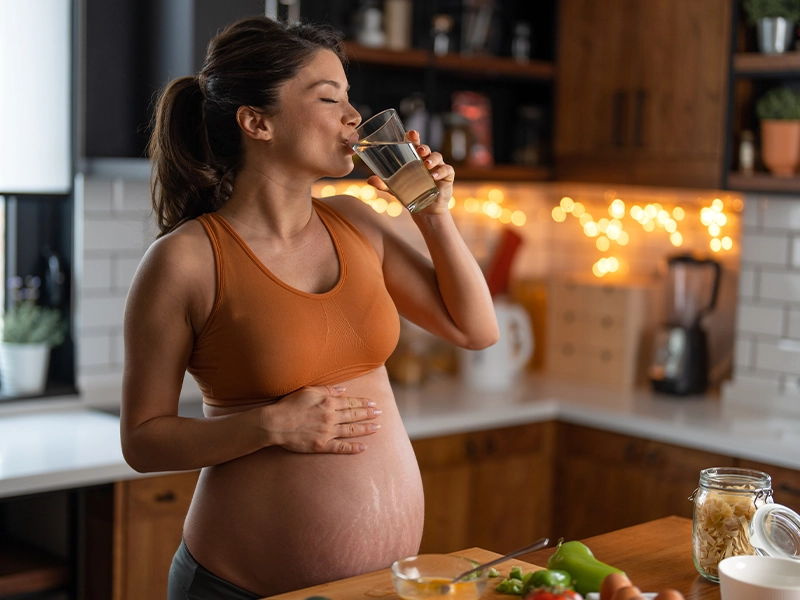 pregnant woman drinking water