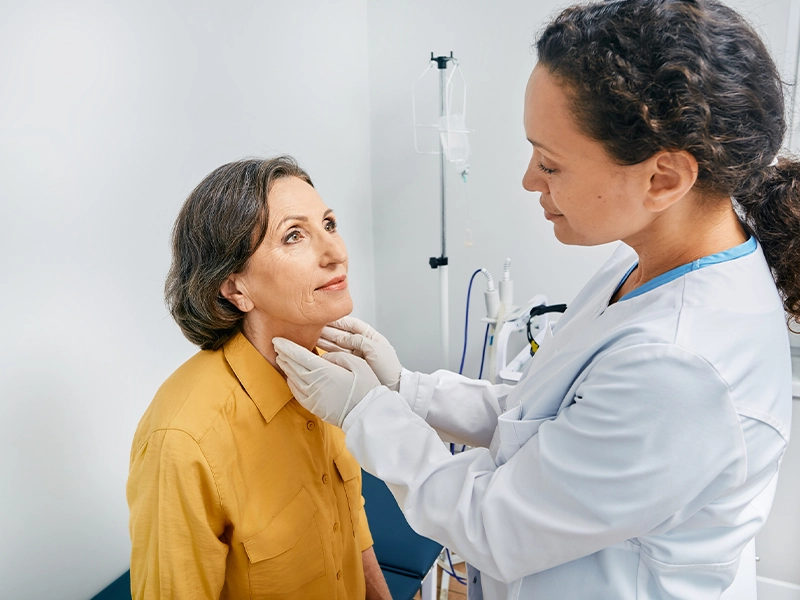 A doctor checking a woman in her office