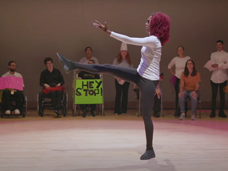 Woman dancing in front of people