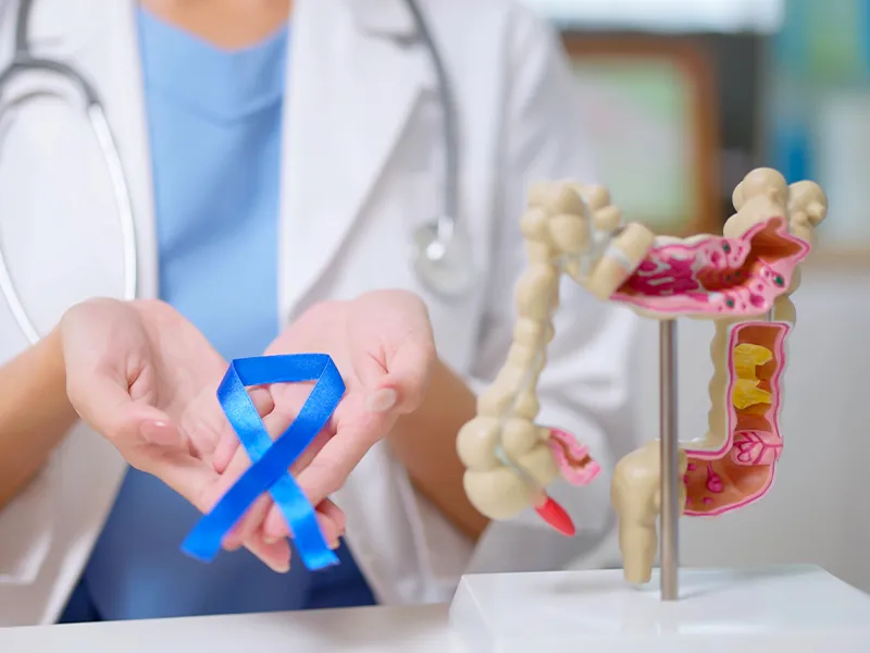 closeup of a hand showing colon dummy