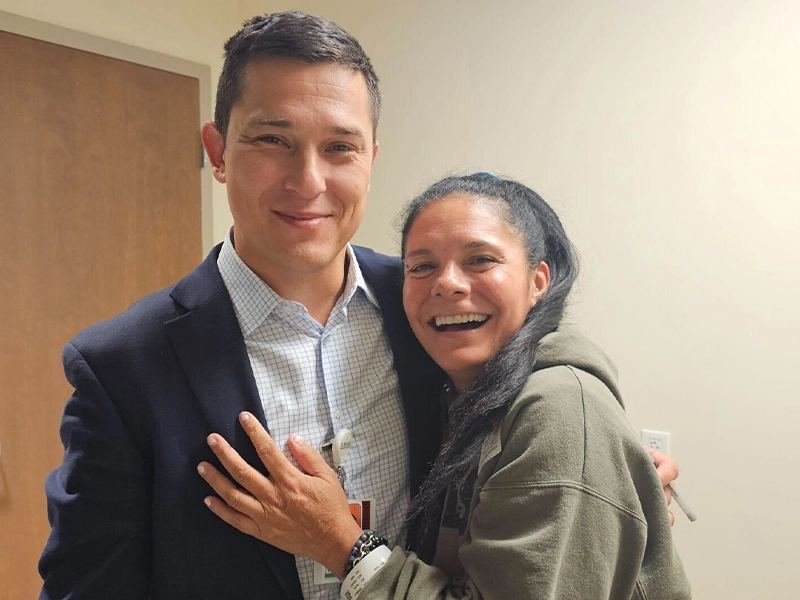 selfie where a couple embrace each other smiling at the camera