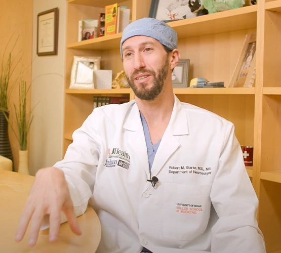 Doctor speaking to the camera from her office