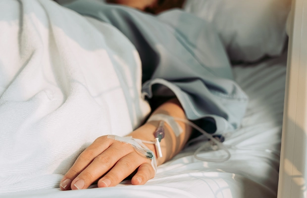 Close-up of a sick woman lying in bed