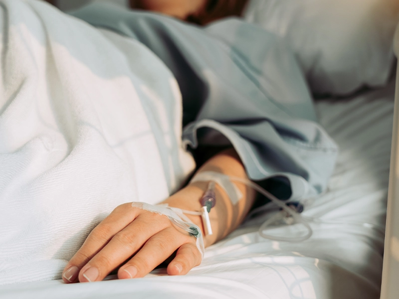 Close-up of a sick woman lying in bed