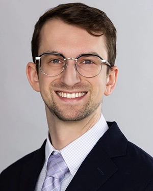 Close-up of a man wearing a suit.