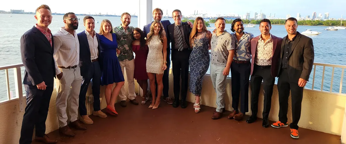 large group of people posing and smiling at the camera