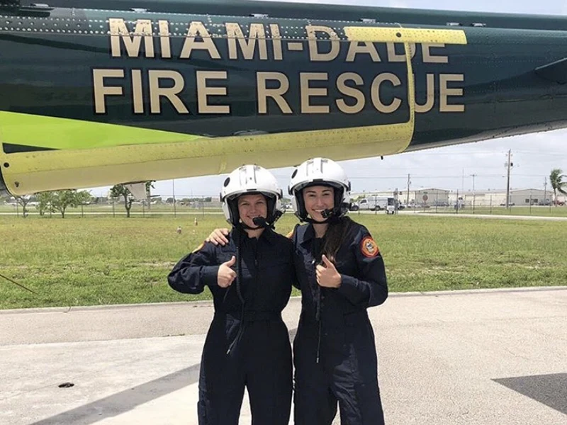 two women wearing helmet