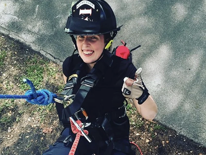 woman with thumb up wearing helmet