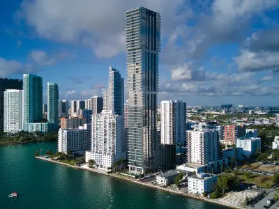 photography of buildings, the tallest one is in the middle of two others
