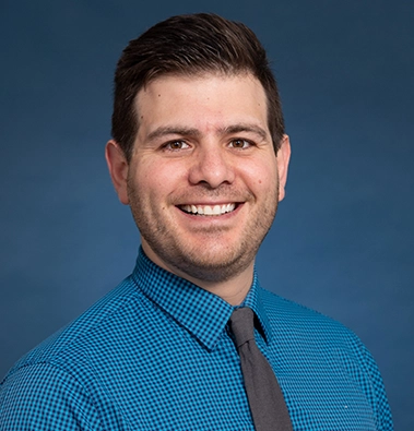 Close-up of a man wearing a blue shirt and tie