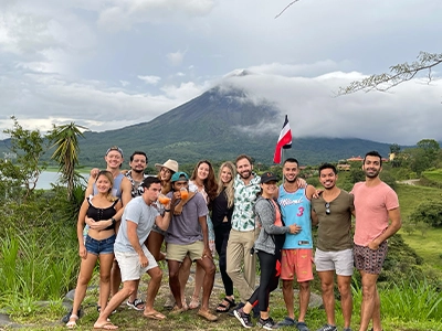group of people posing and smiling at camera outdoors