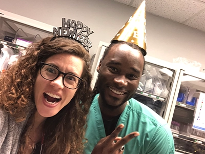selfie of man and woman wearing birthday hat
