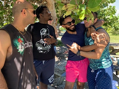 four man smiling at each other