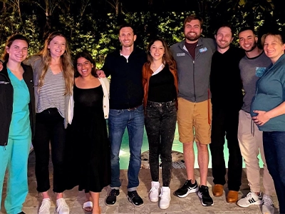 group of people posing and smiling at the camera