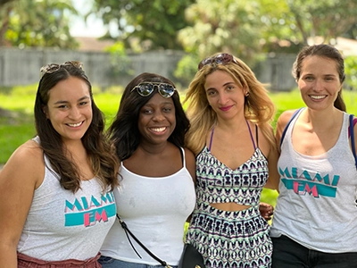 four women smiling and posing at the camera