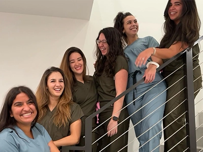 group of women posing from the stairs wearing doctors' uniforms