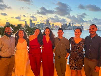 seven people in suits posing at the camera