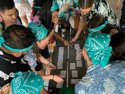 group of people selecting cards on a table