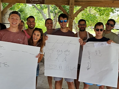 group of man showing banners with drawings at camera