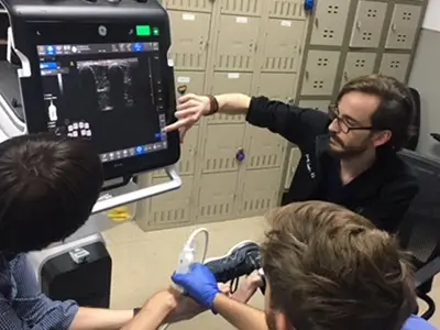 doctor and patient reviewing ultrasound screen