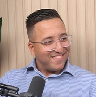 Close-up of a man speaking into a microphone.
