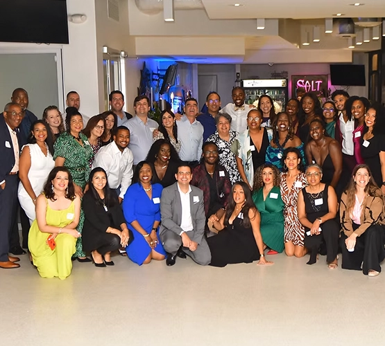 large group of people dressed up posing and smiling at the camera