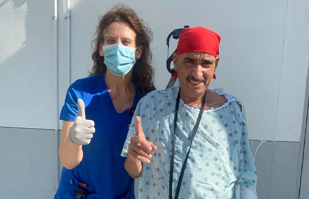 nurse and man in scrubs posing at the camera
