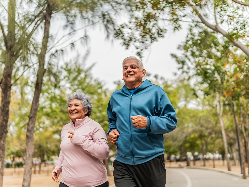 elderly couple running in the park