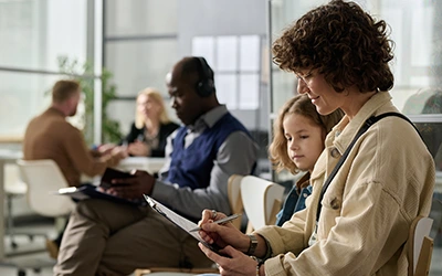 Patients waiting in a lobby and filling out paperwork