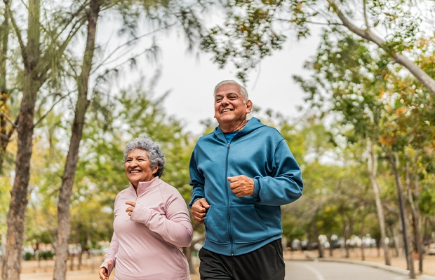 elderly couple running in the park