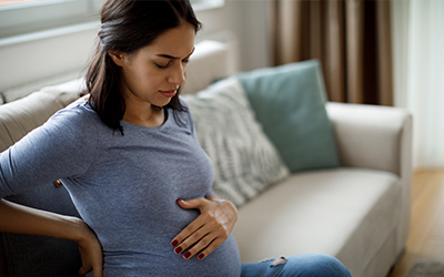pregnant woman feeling her belly