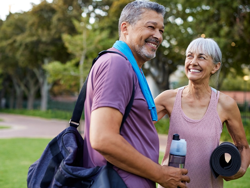 elderly couple walking in the park