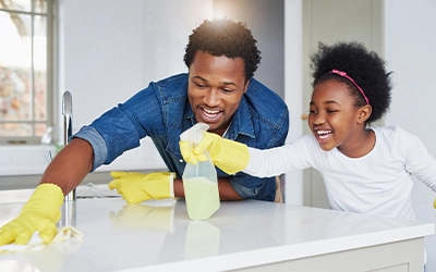 father and daughter cleaning their house