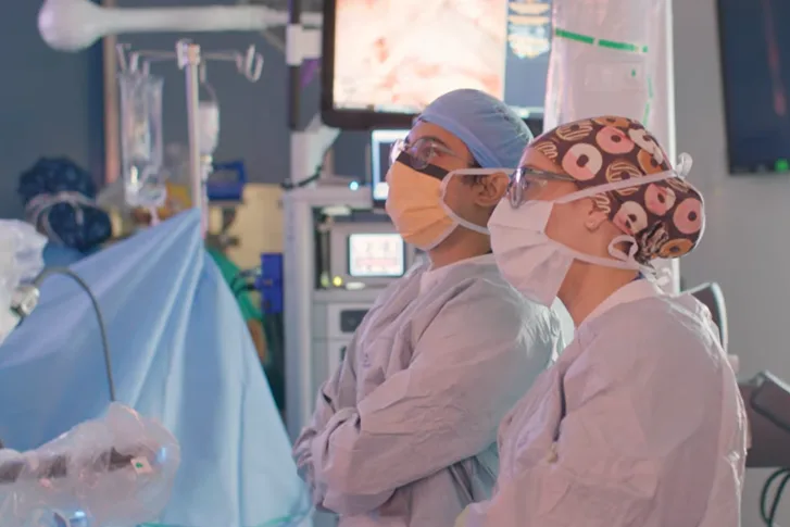 Medical professionals during a surgery looking up