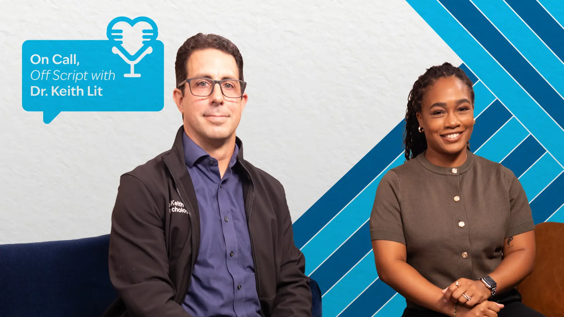 Two people sit next to each other in front of a white wall with blue chevron graphic elements. From left to right: a man with glasses and a sweater and a woman with a dark top. A teal speech bubble logo with a heart-shaped microphone icon appears in the upper left.