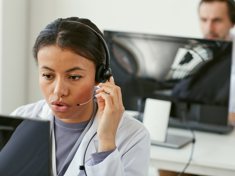 A customer service representative talking on a headset.