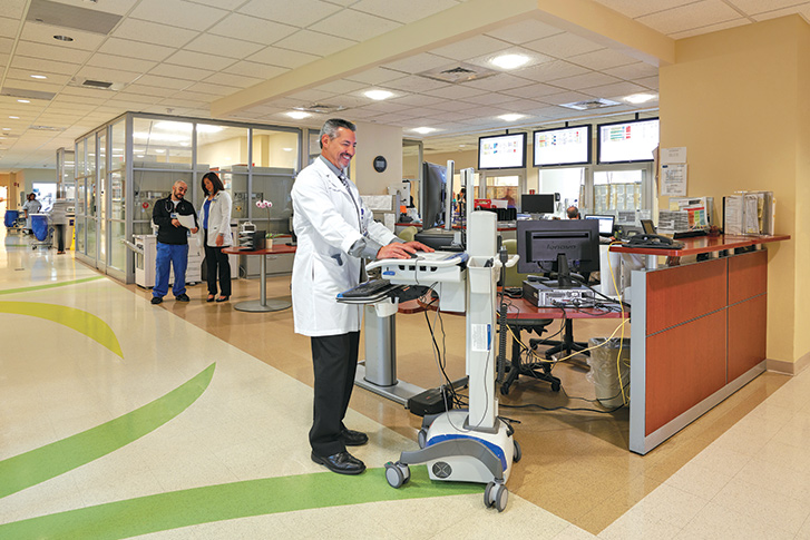 A doctor stands at an emergency room station
