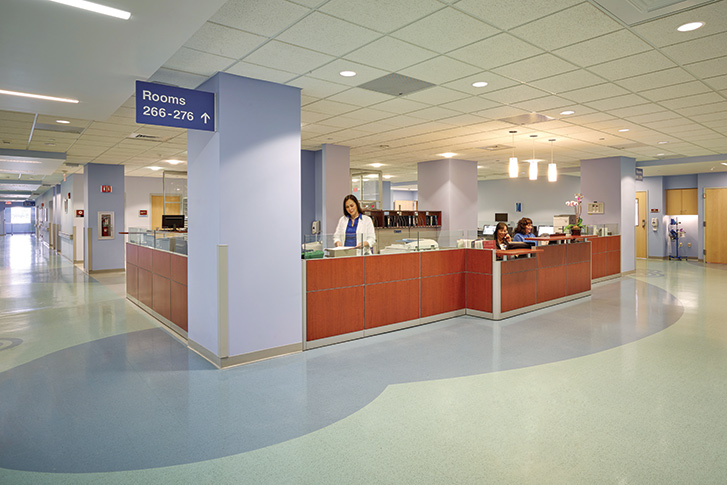 A nurse is working behind a desk