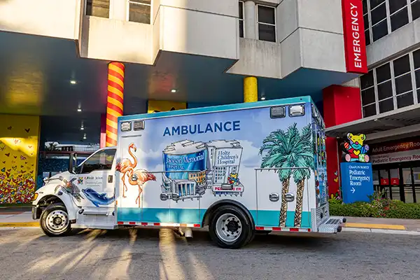 An ambulance for Holtz Children's Hospital outside of a Pediatric Emergency Room